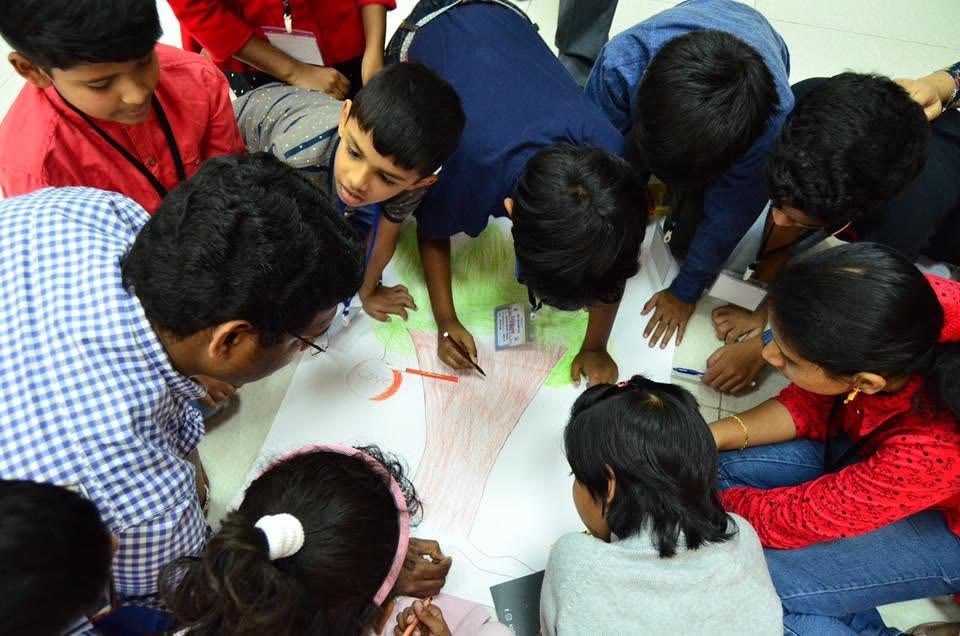 Children drawing together on the floor at Sunday School